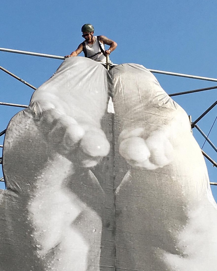 Work in Progress. JR's team install a new piece in Rio. Image courtesy of the artist's Instagram