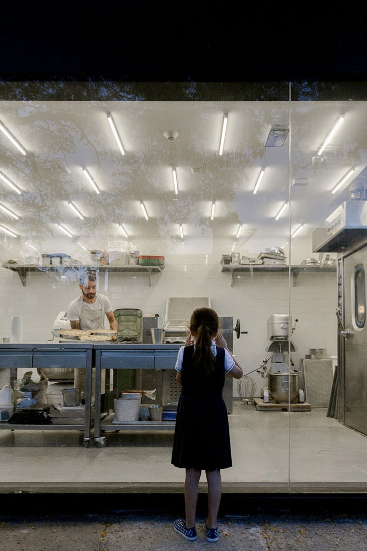 Interior night view from the outside. La Linda Bakery Carrasco by Pedro Livni Architect. Photograph © Pablo Casals Aguirre