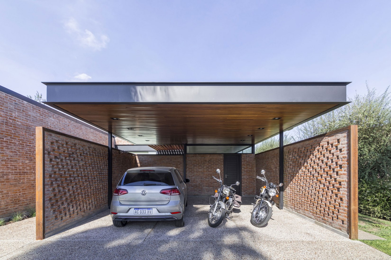 Garage. House in San Marino, Funes Hills by Mariel Suárez. Photograph by Ramiro Sosa