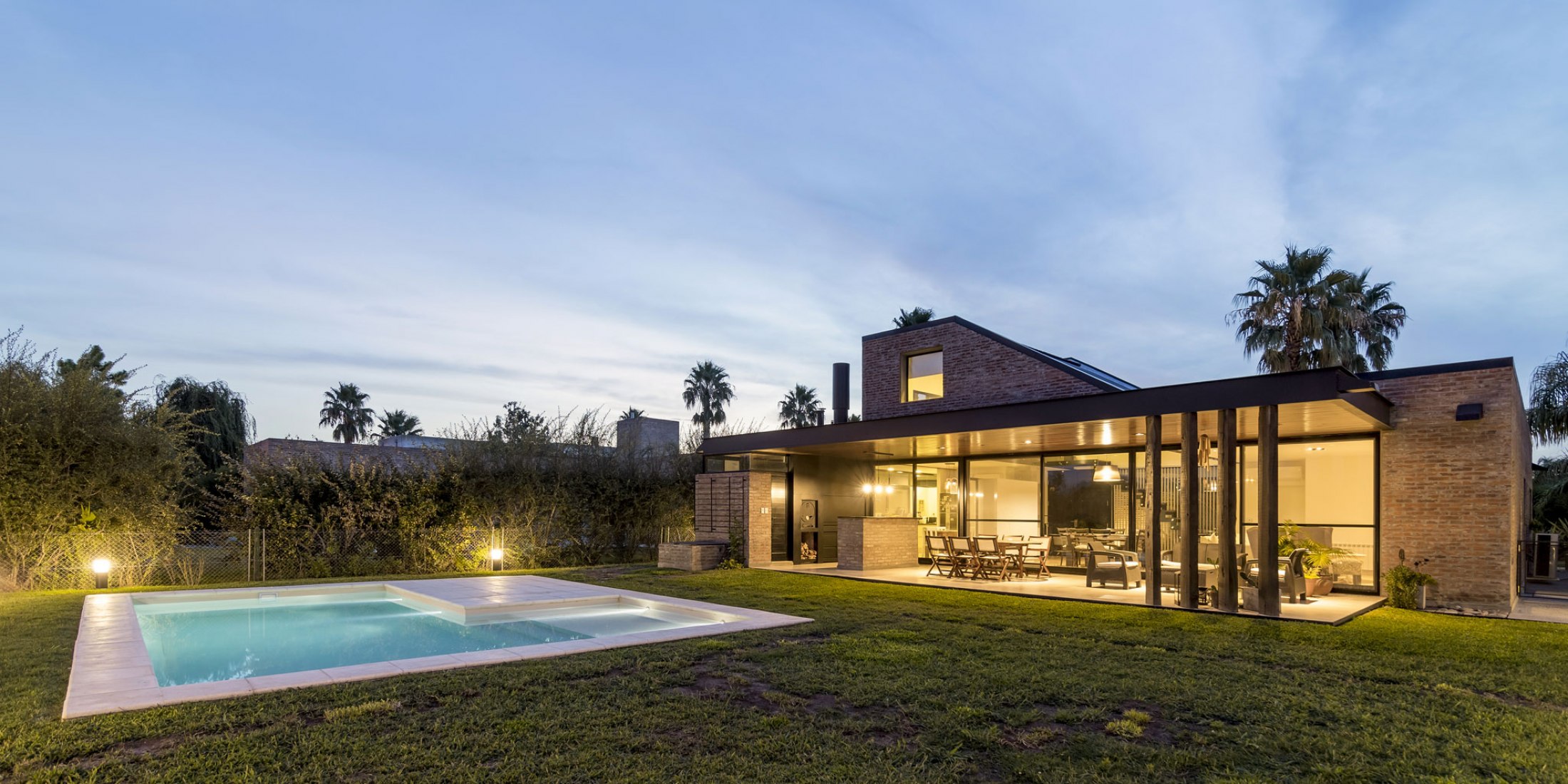 Nigth view. House in San Marino, Funes Hills by Mariel Suárez. Photograph by Ramiro Sosa