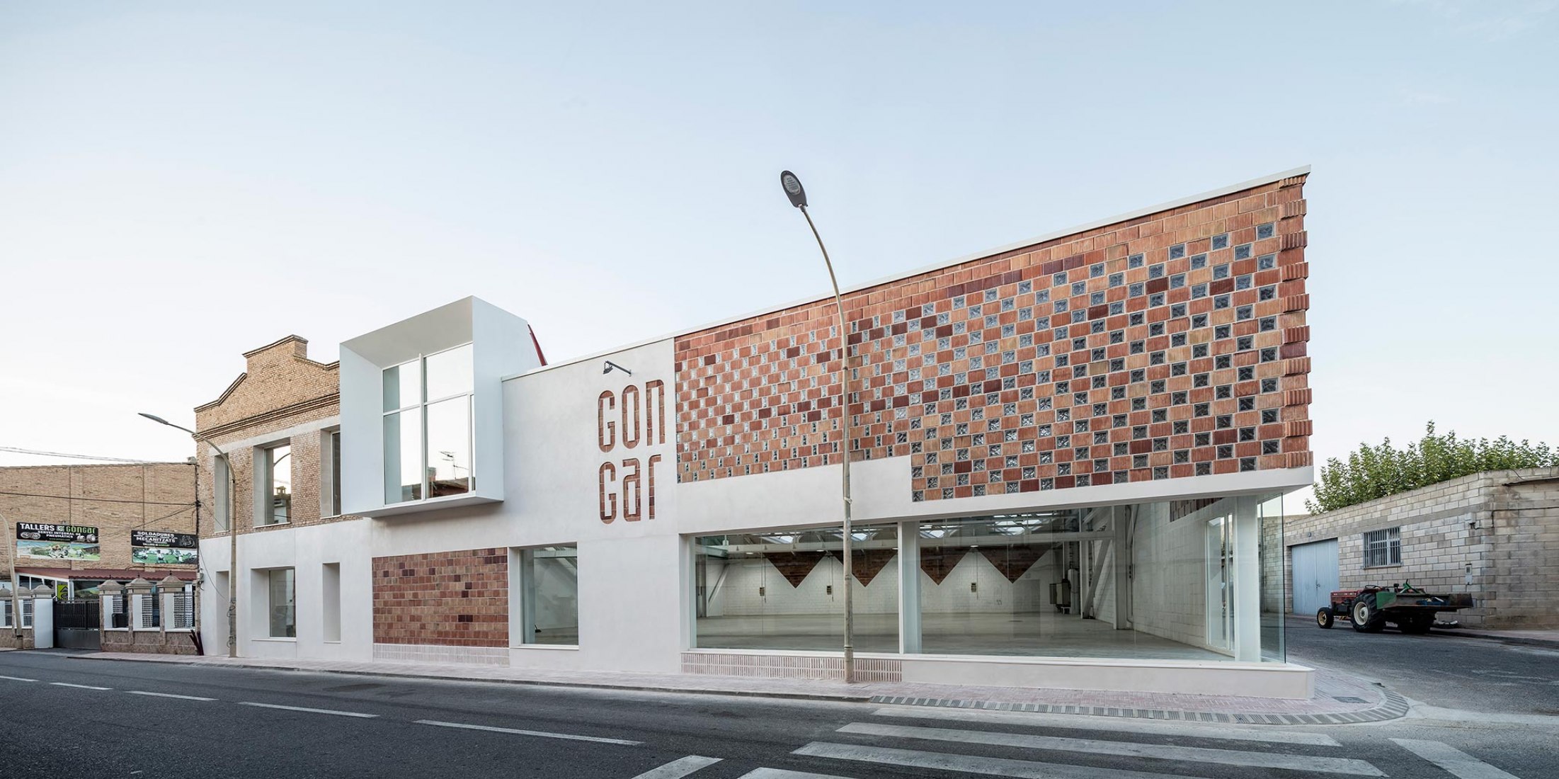 Exterior view. Rehabilitation and expansion of the Gon-Gar Workshops by NUA arquitectures. Photograph © Adriá Goula