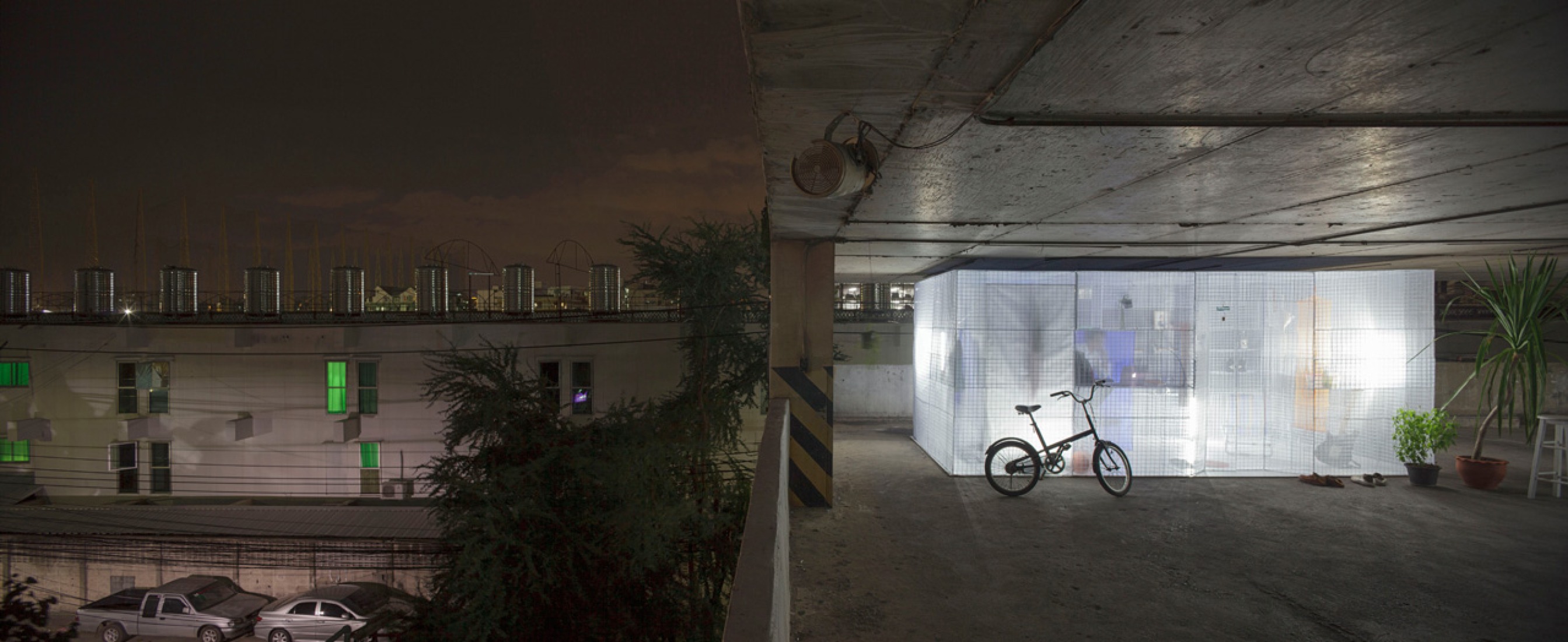 Exterior view since the parking garage. Minimalist Pop-up Houses in a parking garage of Bangkok. Photography © Soopakorn Srisakul.