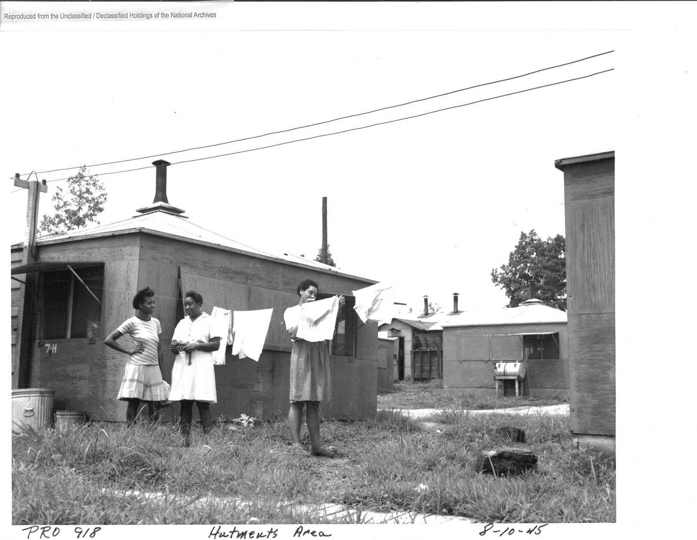 African American women hanging laundry in a hutment area, Oak Ridge, 1945. Despite their often forward-looking design and planning, the three Secret Cities of the Manhattan Project treated racial segregation as a given. In Oak Ridge, many African American workers lived in plywood “hutments.” The contrast between these crude, ill-heated huts and the comfortable housing built for most white workers was stark. Photo by Edward Westcott. National Archives and Records Administration