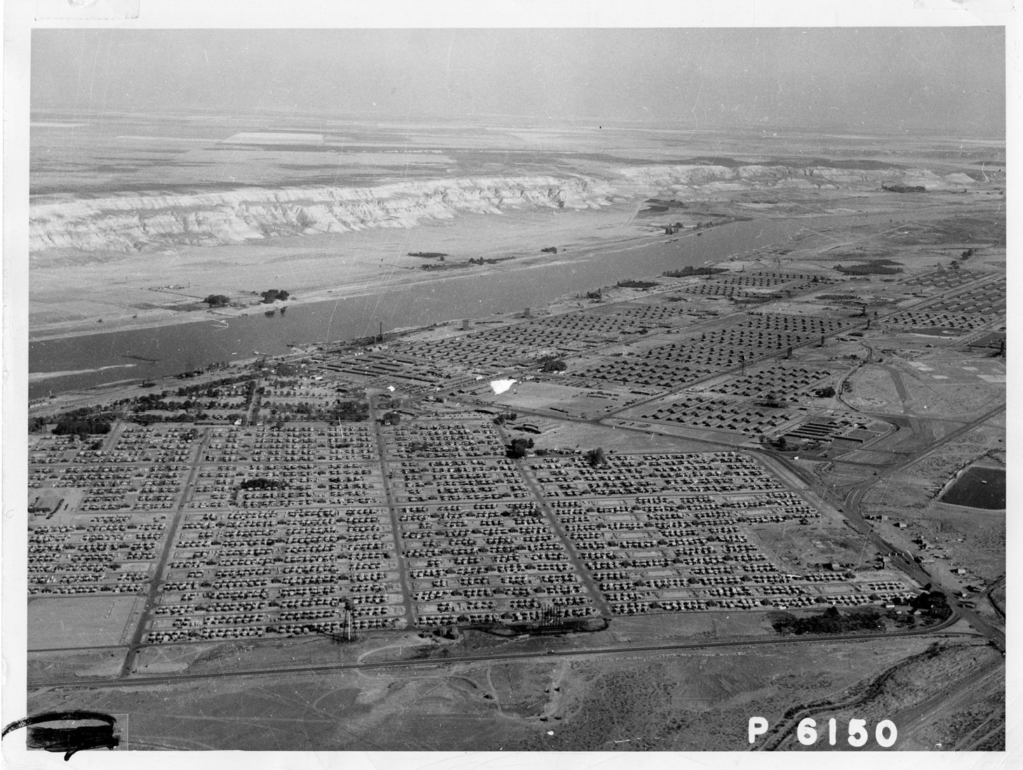 Aerial view of Hanford Construction Camp, ca. 1945. The camp for construction workers at Hanford ultimately housed upwards of 50,000 people, making it the fourth largest “city” in the state of Washington. Item courtesy of the U.S. Department of Energy, Hanford Collection