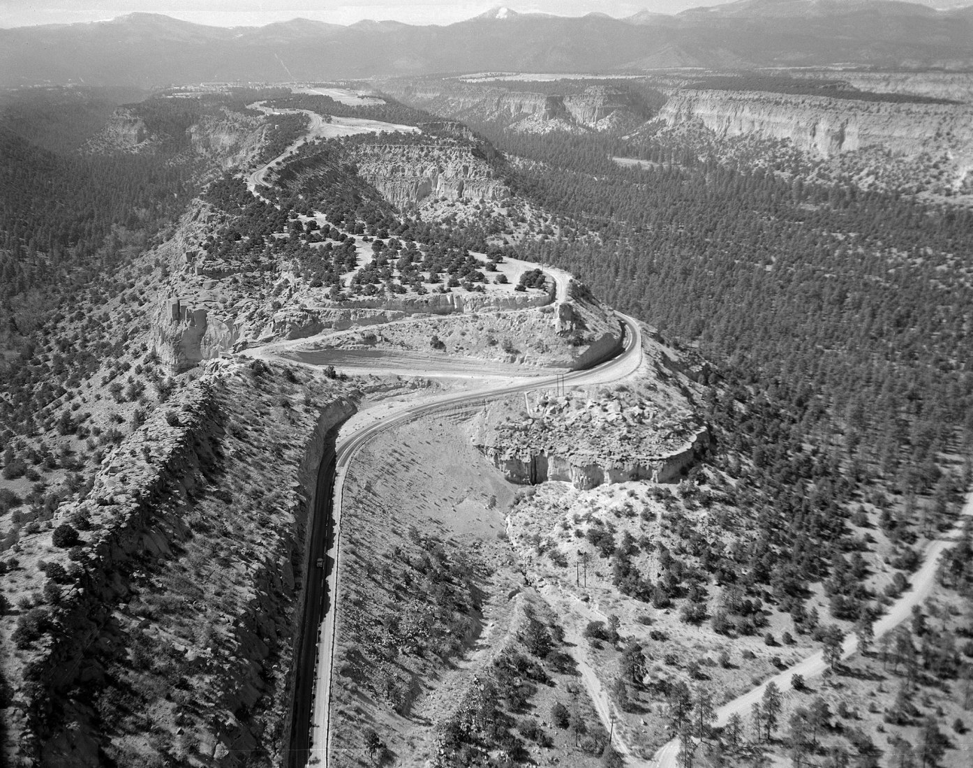 Road to Los Alamos, ca. 1943-45. The sites selected for the three Secret Cities all took advantage of natural barriers to enhance security and secrecy. Los Alamos, for instance, was sited at the top of an isolated plateau. The steep, curving road leading to the city was a nerve-wracking experience for drivers. Courtesy of the Los Alamos National Laboratory Archives