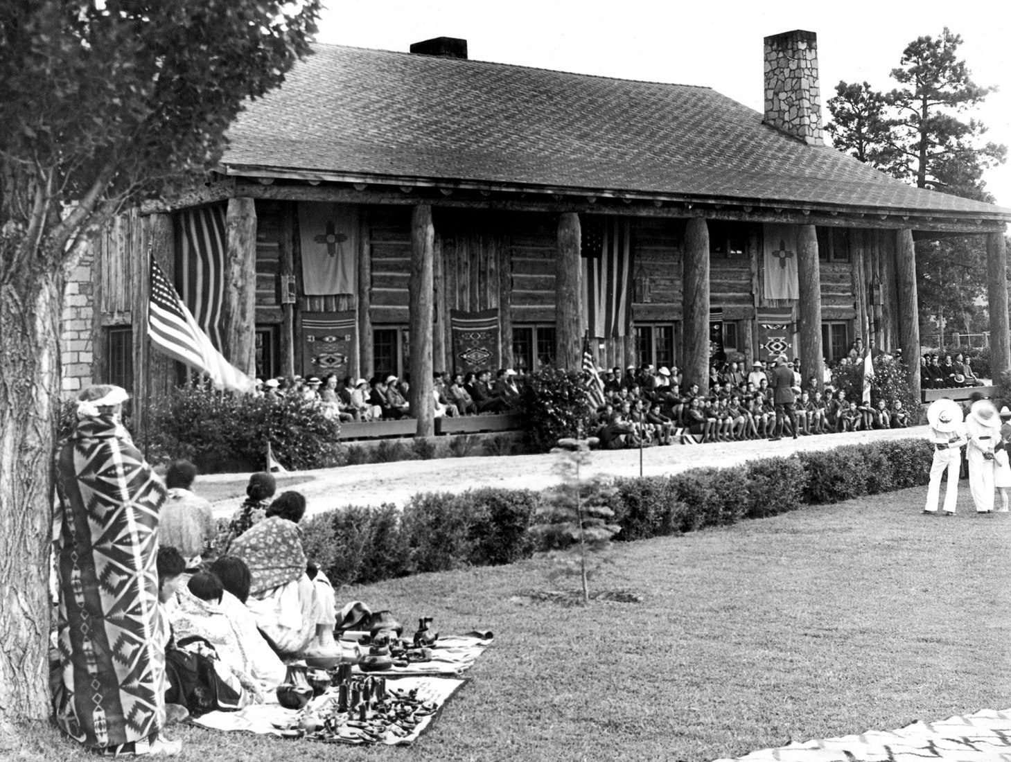 Graduation ceremony at the Los Alamos Ranch School, ca. 1930s. At Los Alamos, the federal government appropriated property belonging to the Los Alamos Ranch School, a private boarding school for wealthy boys. The school campus included a number of distinctive log buildings, which were adapted for military use during the war. Seen here is Fuller Lodge, which served Manhattan Project workers as a dining hall and assembly space. Courtesy of the Los Alamos Historical Society Photo Archives 