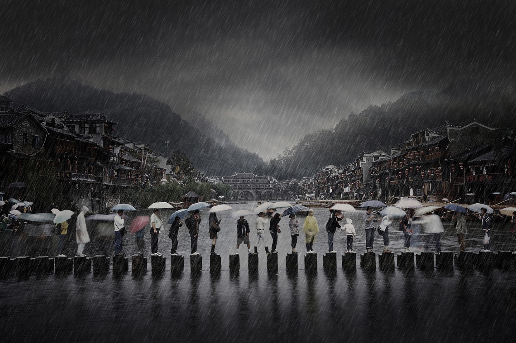 Winner, Travel, Open Competition: My photo "Rain in Ancient Town" was shot in southern China - Phoenix Town - which shows a scene of people traveling in the rain during the rainy season. In the background there are old residential buildings and an old stone bridge. (© Chen Li, 2014 Sony World Photography Awards)