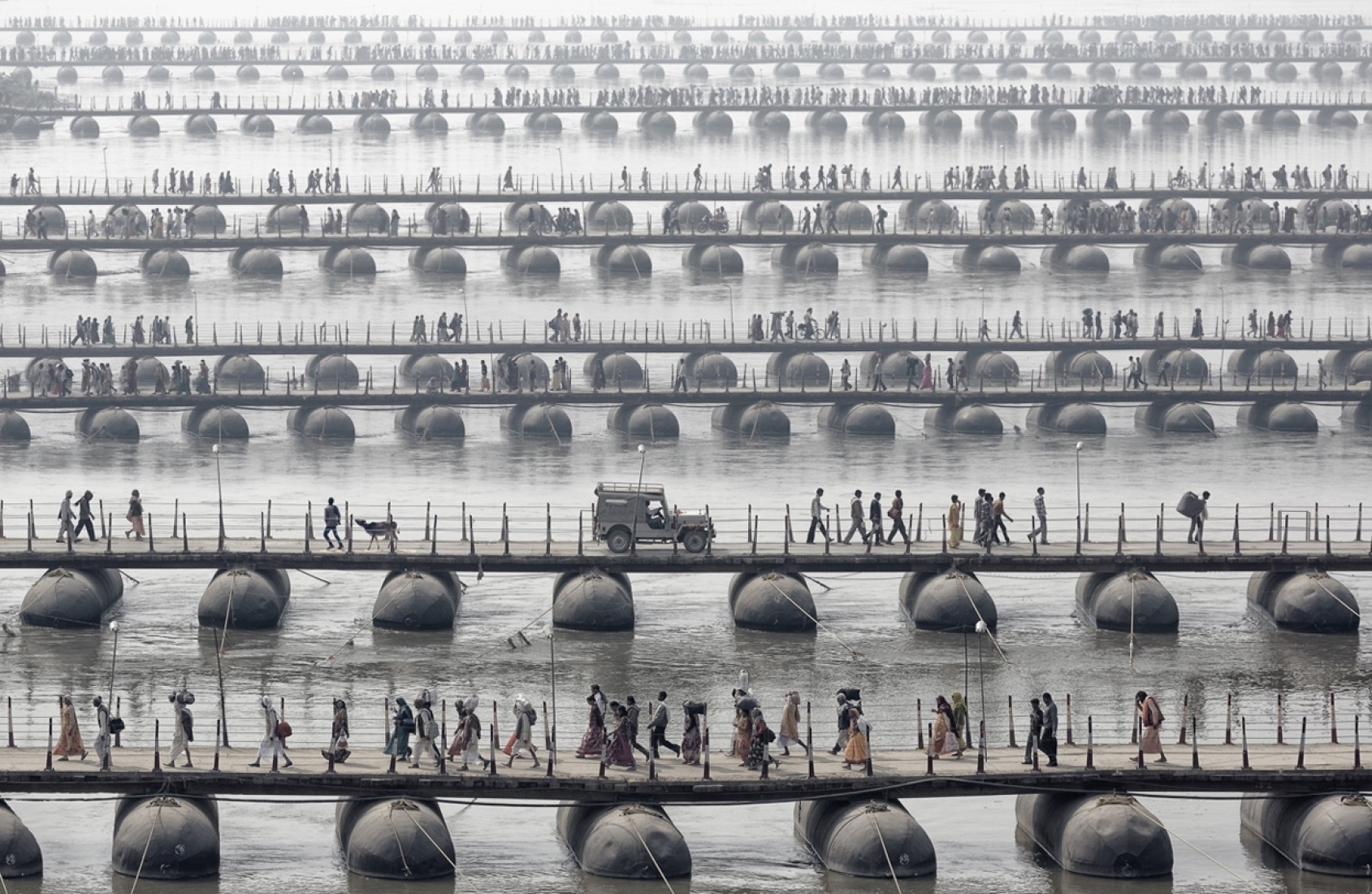3rd Place, Germany, National Awards: Pilgrims and devotees cross pontoon bridges at the Maha Kumbh Mela - the largest spiritual gathering on the planet, held every 12 years in India. (© Wolfgang Weinhardt, 2014 Sony World Photography Awards).