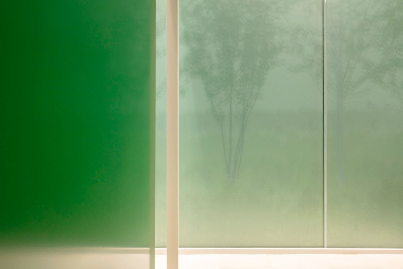 Frosted glass reveals the patterns of trees. Andon Toilet. Toilet in Nishihara Itchome Park by Takenosuke Sakakura. Photograph by Satoshi Nagare, courtesy of the Nippon Foundation
