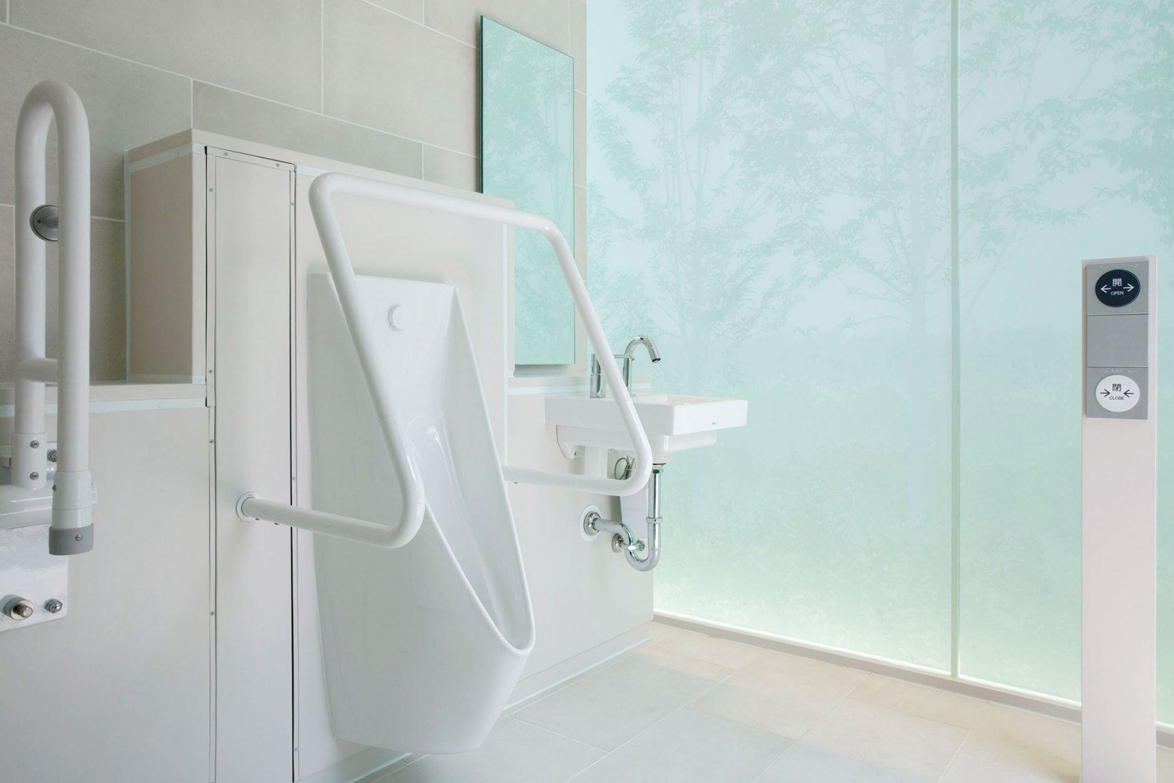 The unisex stalls are equipped with large and small toilets and a sink. Andon Toilet. Toilet in Nishihara Itchome Park by Takenosuke Sakakura. Photograph by Satoshi Nagare, courtesy of the Nippon Foundation