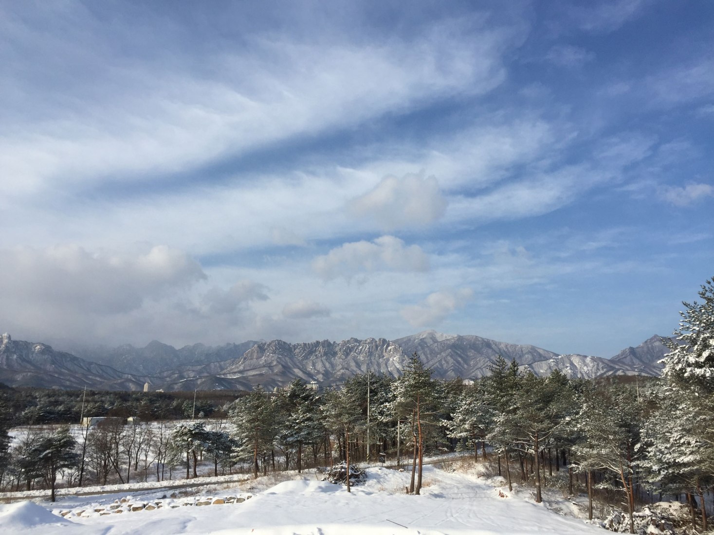 View to Seorak Mountain. House [in white] by AEV Architectures. Photograph by Hyunjune Lee