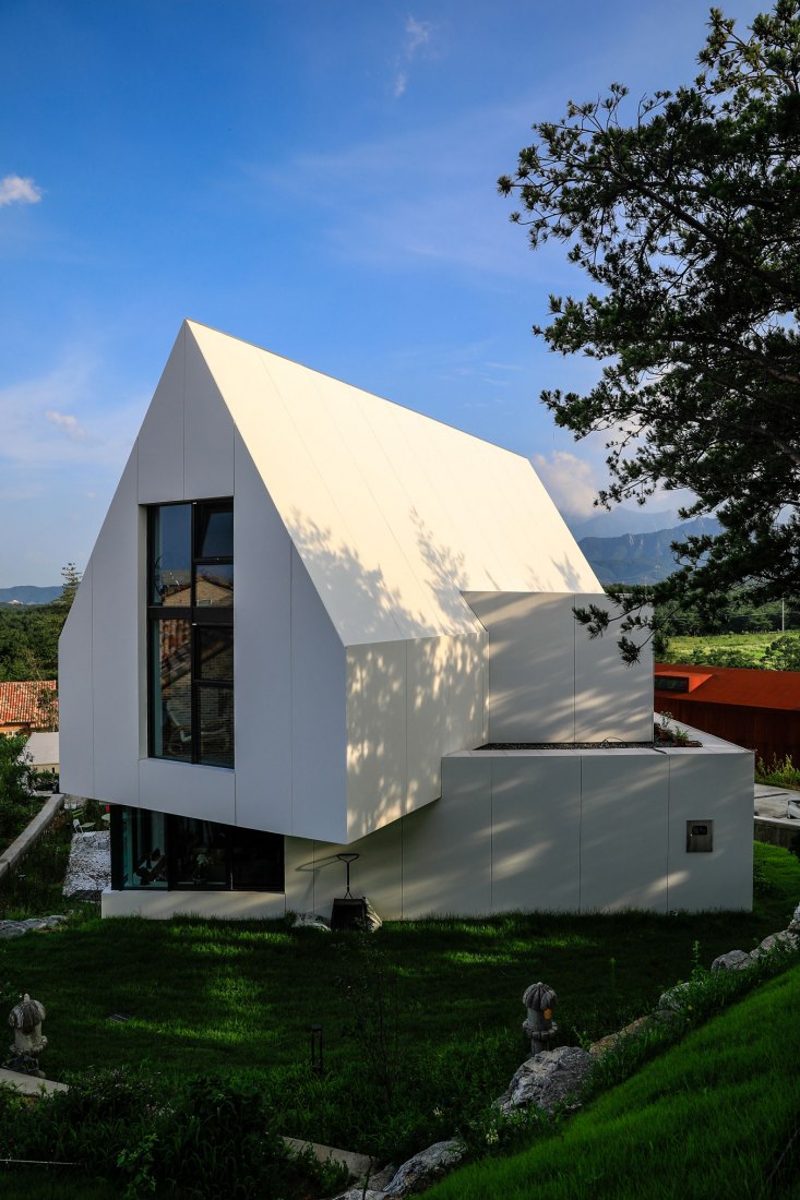 Exterior. House [in white] by AEV Architectures. Photograph by Hyunjune Lee