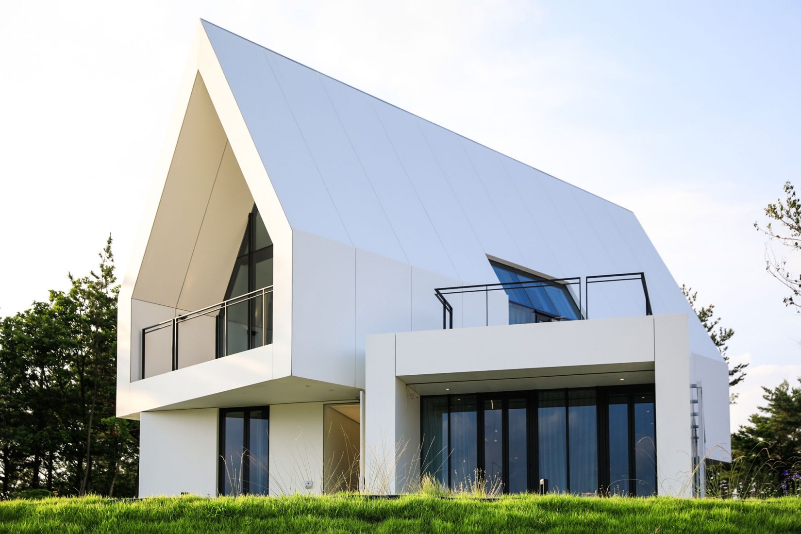 Exterior. House [in white] by AEV Architectures. Photograph by Hyunjune Lee