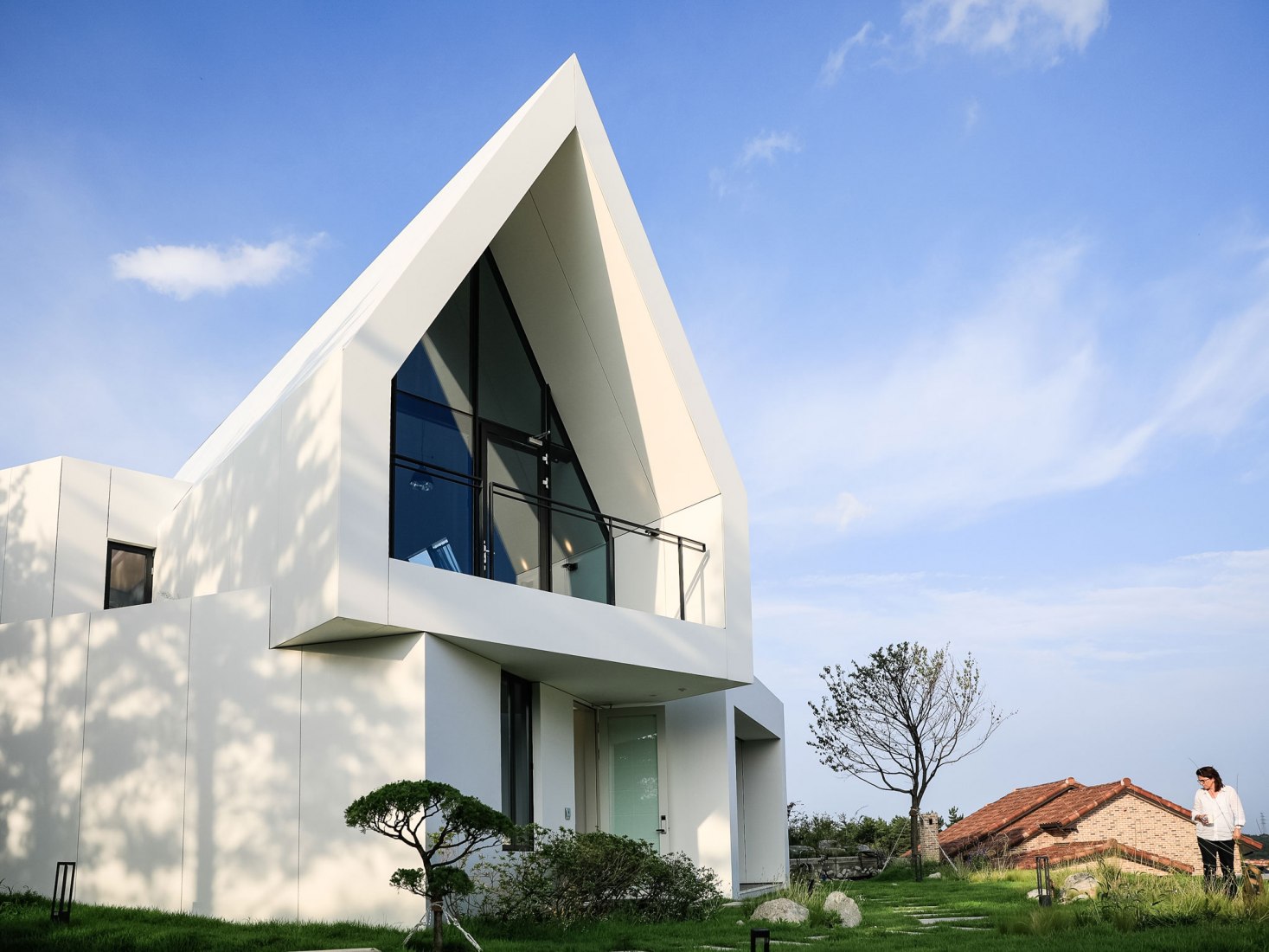 Exterior. House [in white] by AEV Architectures. Photograph by Hyunjune Lee