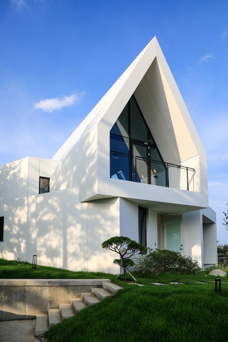 Exterior. House [in white] by AEV Architectures. Photograph by Hyunjune Lee