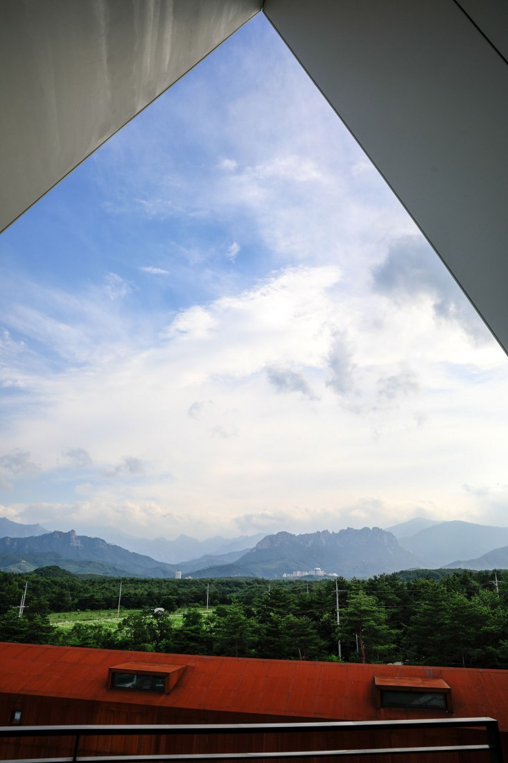 View from inside. House [in white] by AEV Architectures. Photograph by Hyunjune Lee