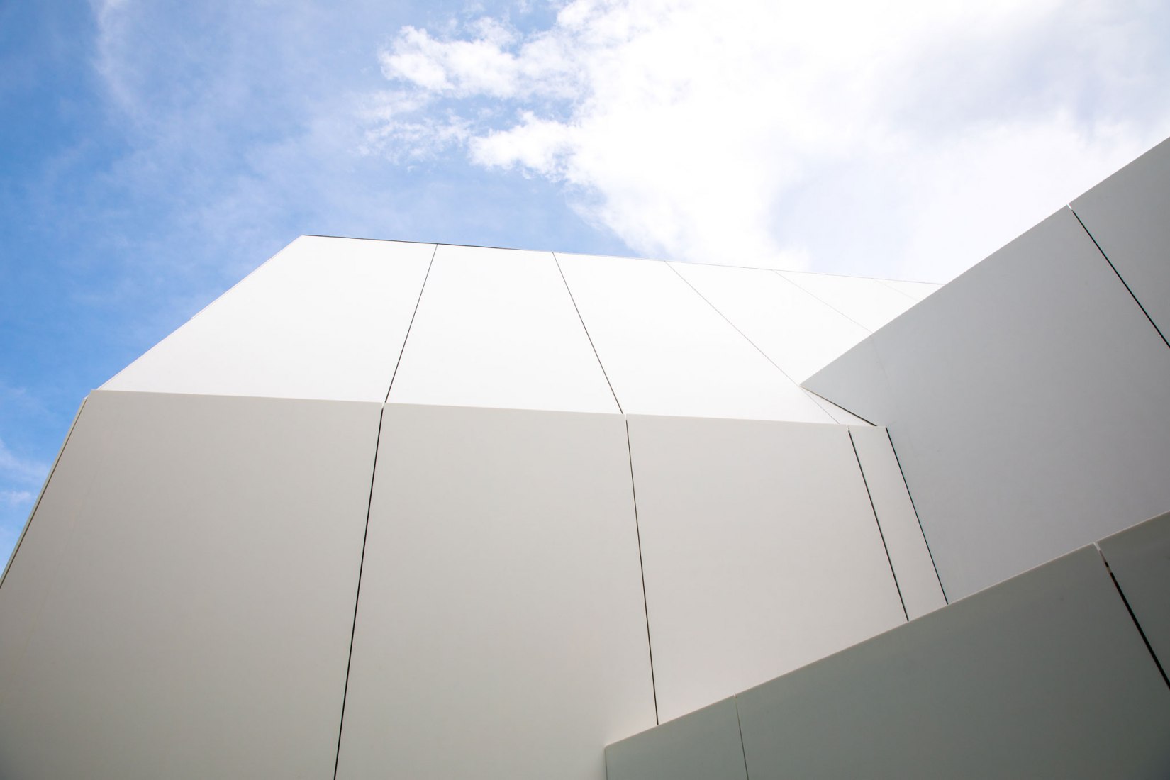 Facade detail. House [in white] by AEV Architectures. Photograph by Hyunjune Lee
