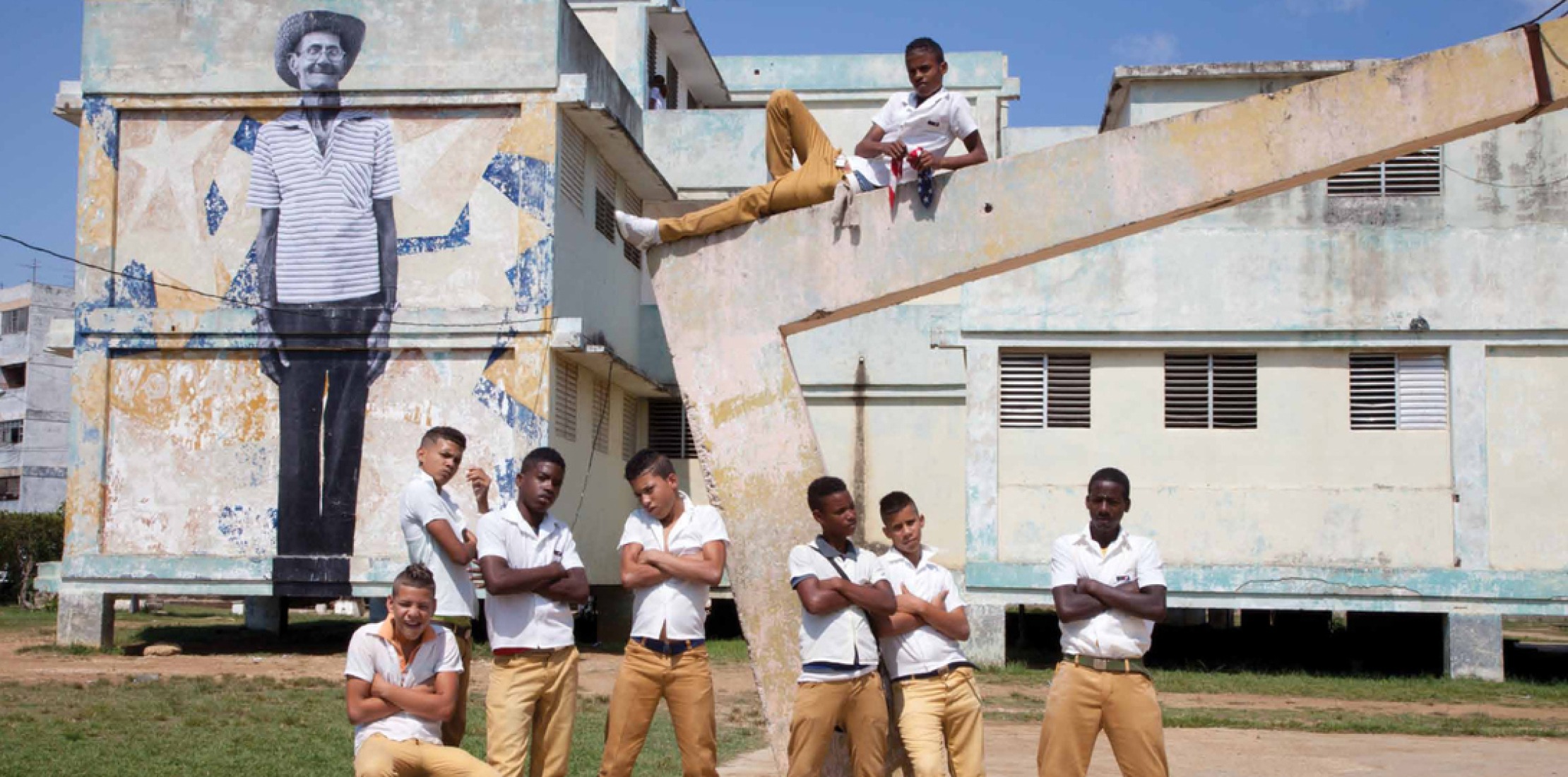 Local school boys gather round. The Wrinkles of the City - La Havana, by José Parlá and JR.