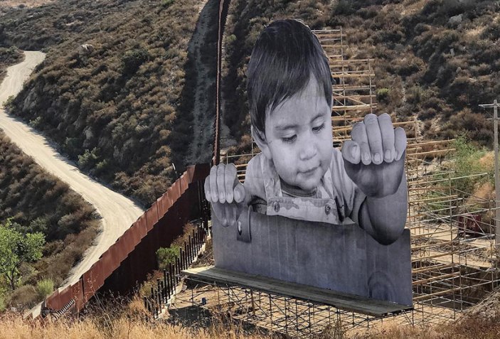 Jr Installs A Huge Image Of Mexican Child On The Border Wall In Tecate The Strength Of Architecture From 1998